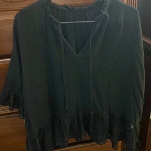 Cropped Black shirt with lace on sleeves and bottom of shirt.